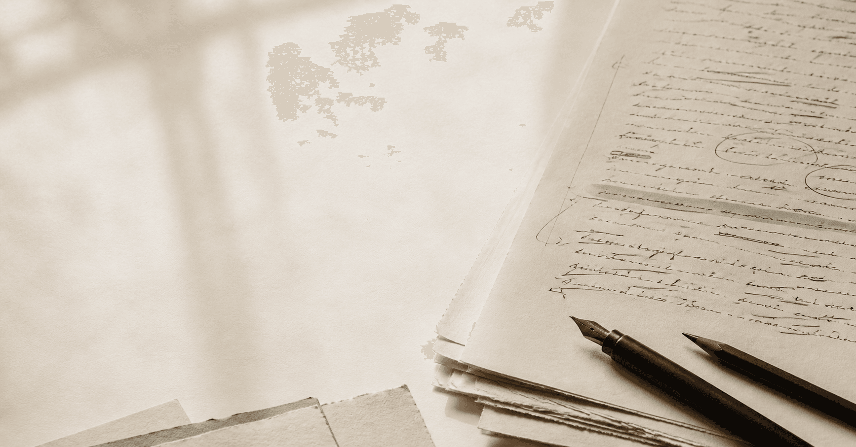 A warm paper manuscript with handwritten revisions, a fountain pen, and a muted green highlight